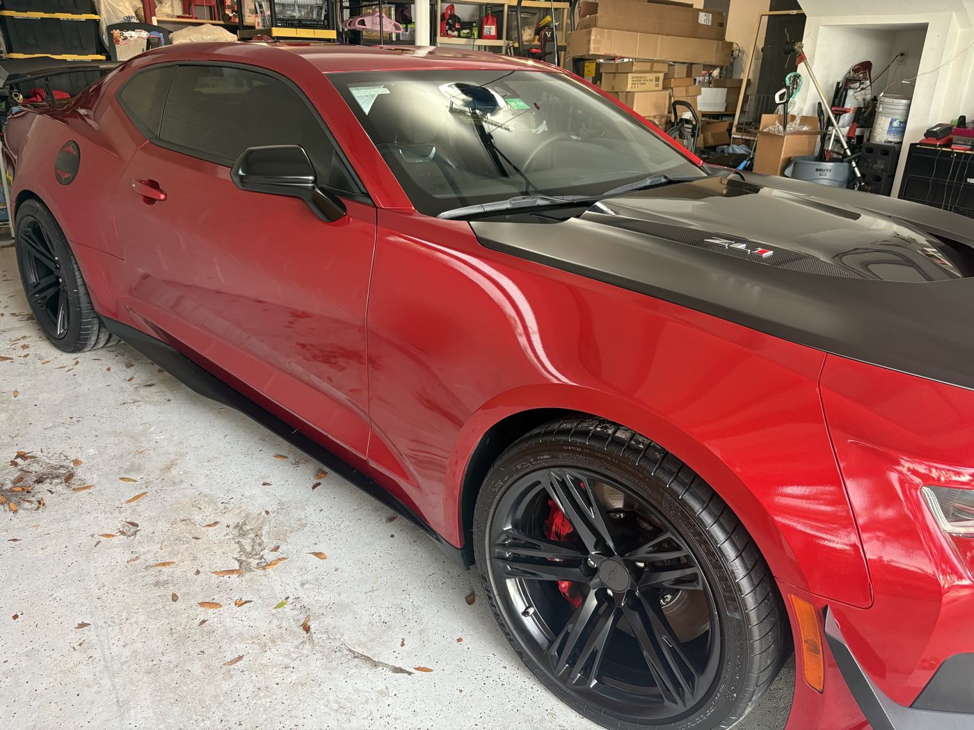 Red Camaro ZL1 side profile with reflections after a detail