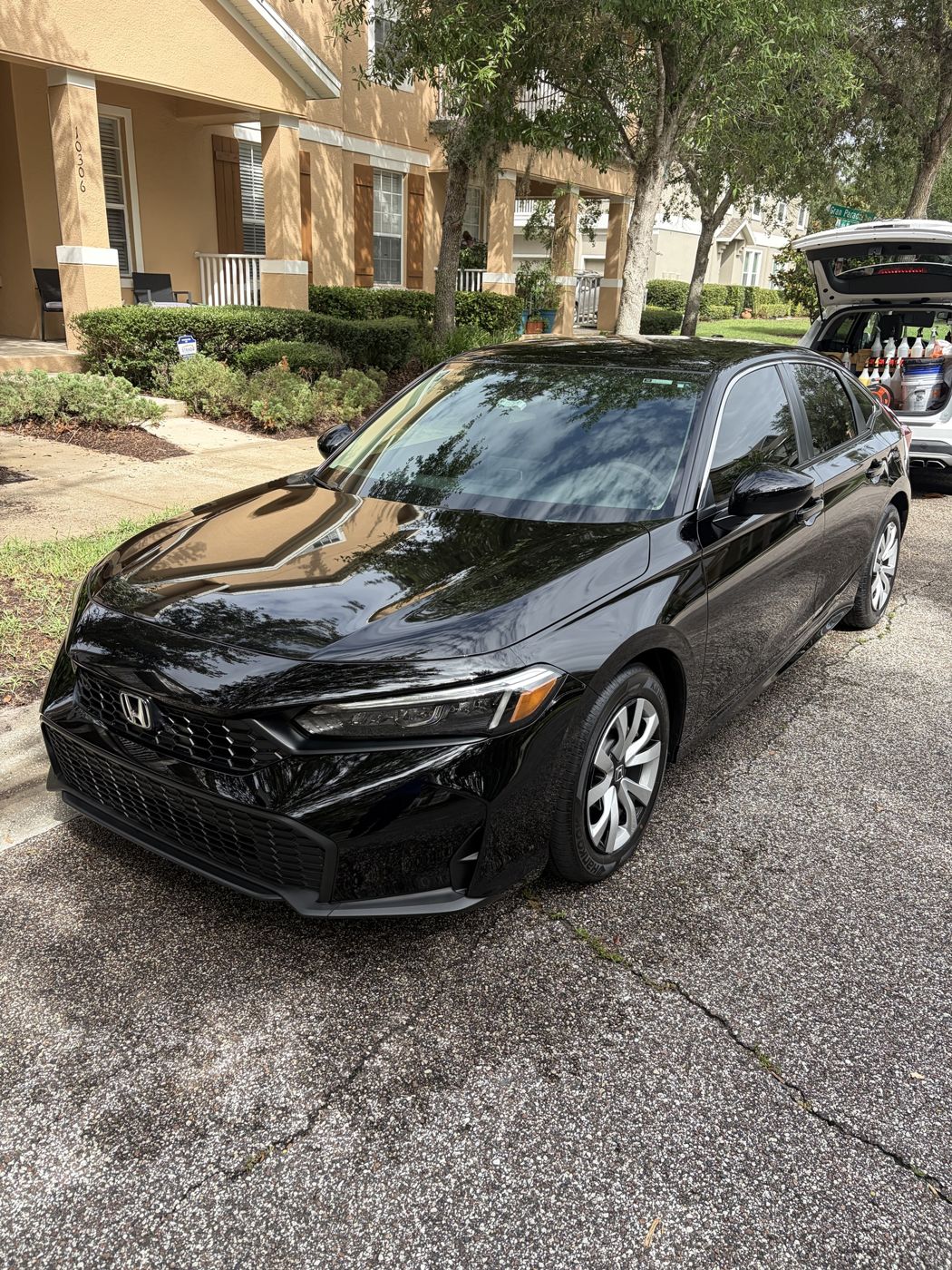 Black Honda Civic with deep reflections after a mobile detail