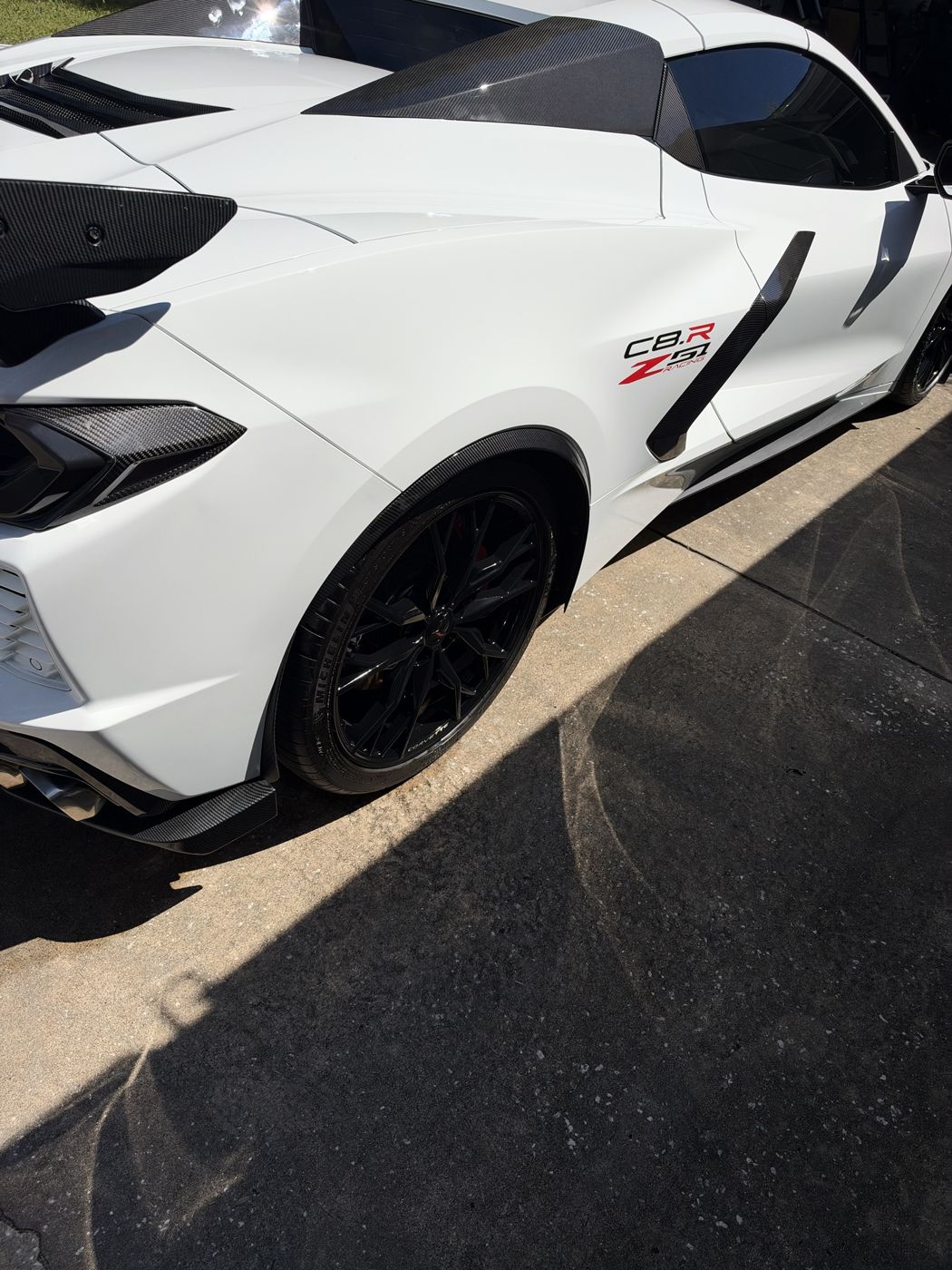 White Corvette C8 rear quarter with carbon fiber aero