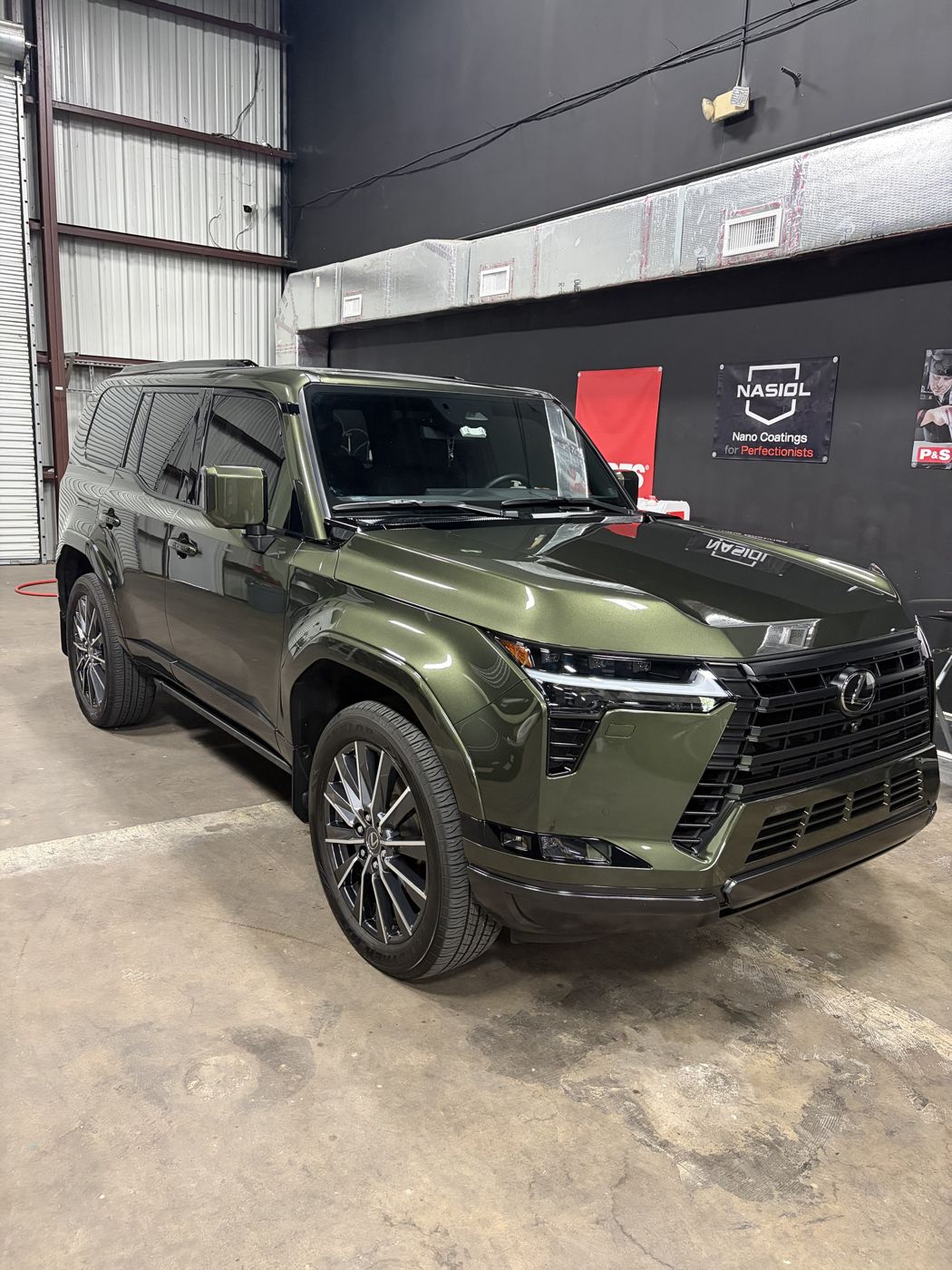 Green Lexus GX with a fresh ceramic coating at the APES shop in Orlando
