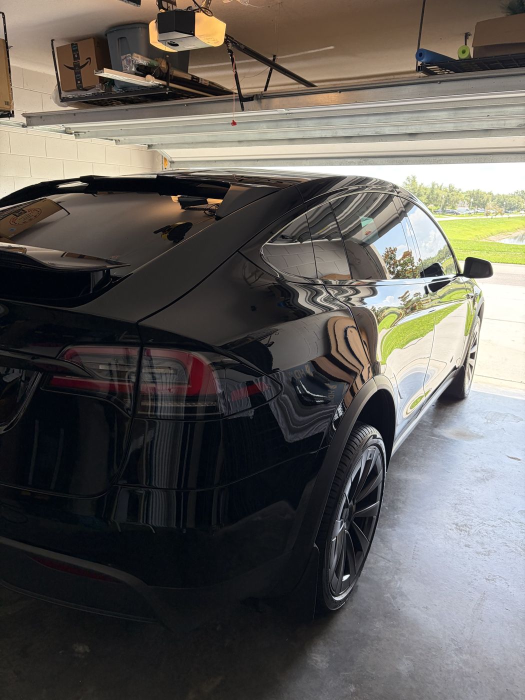Black Tesla Model X in a home garage after a mobile detail